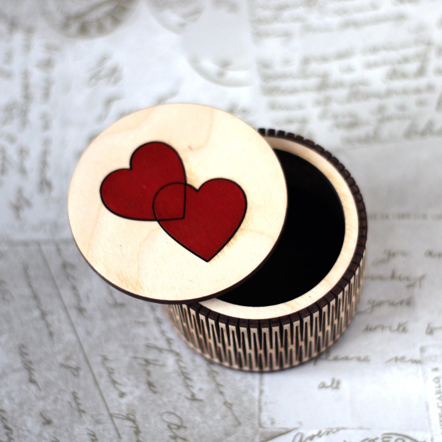 Small wooden trinket box with entwined hearts lid.