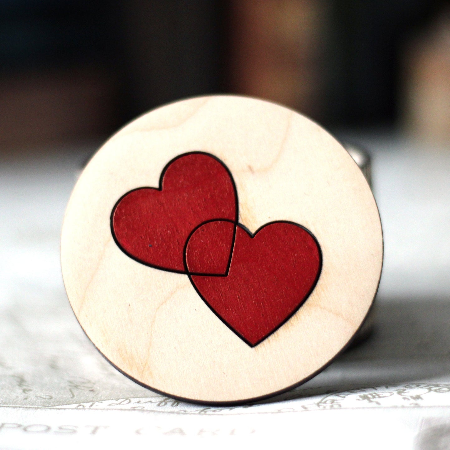 Small wooden trinket box with entwined hearts lid.