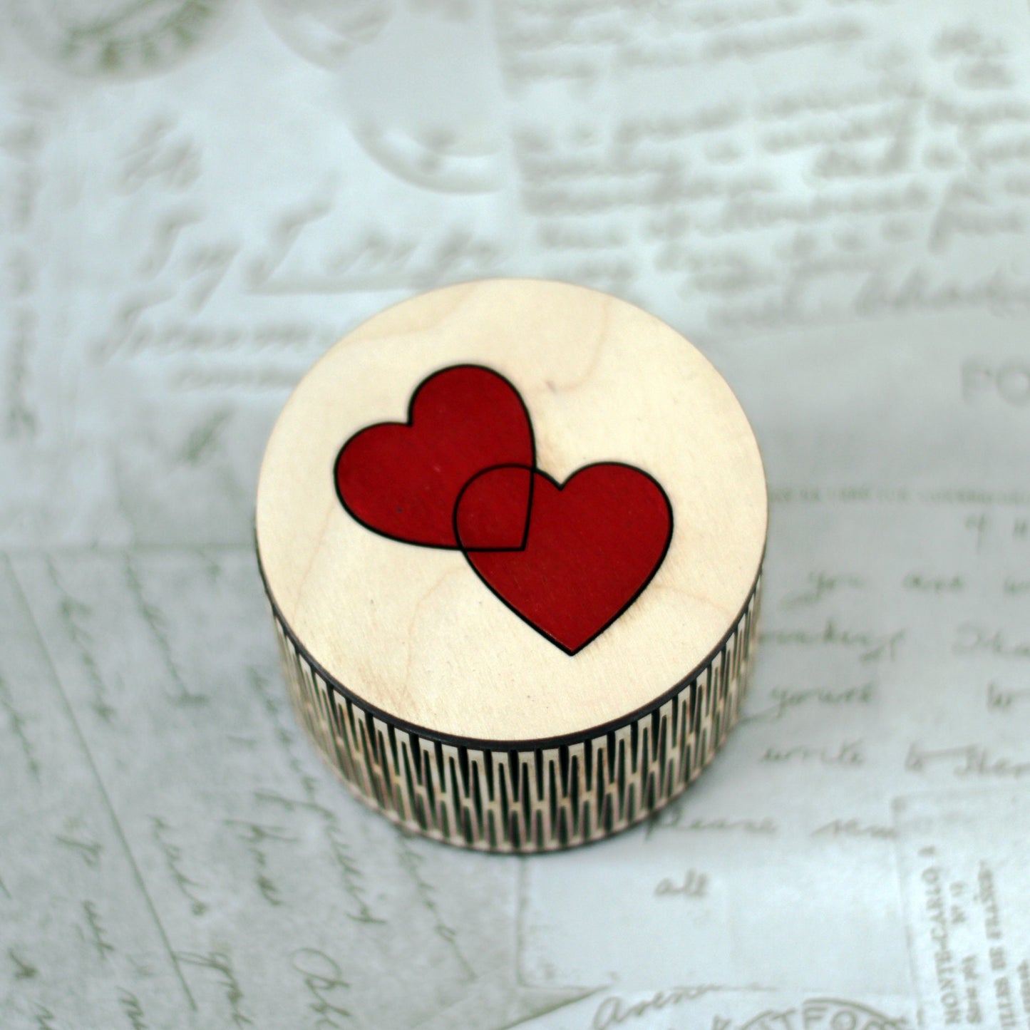 Small wooden trinket box with entwined hearts lid.