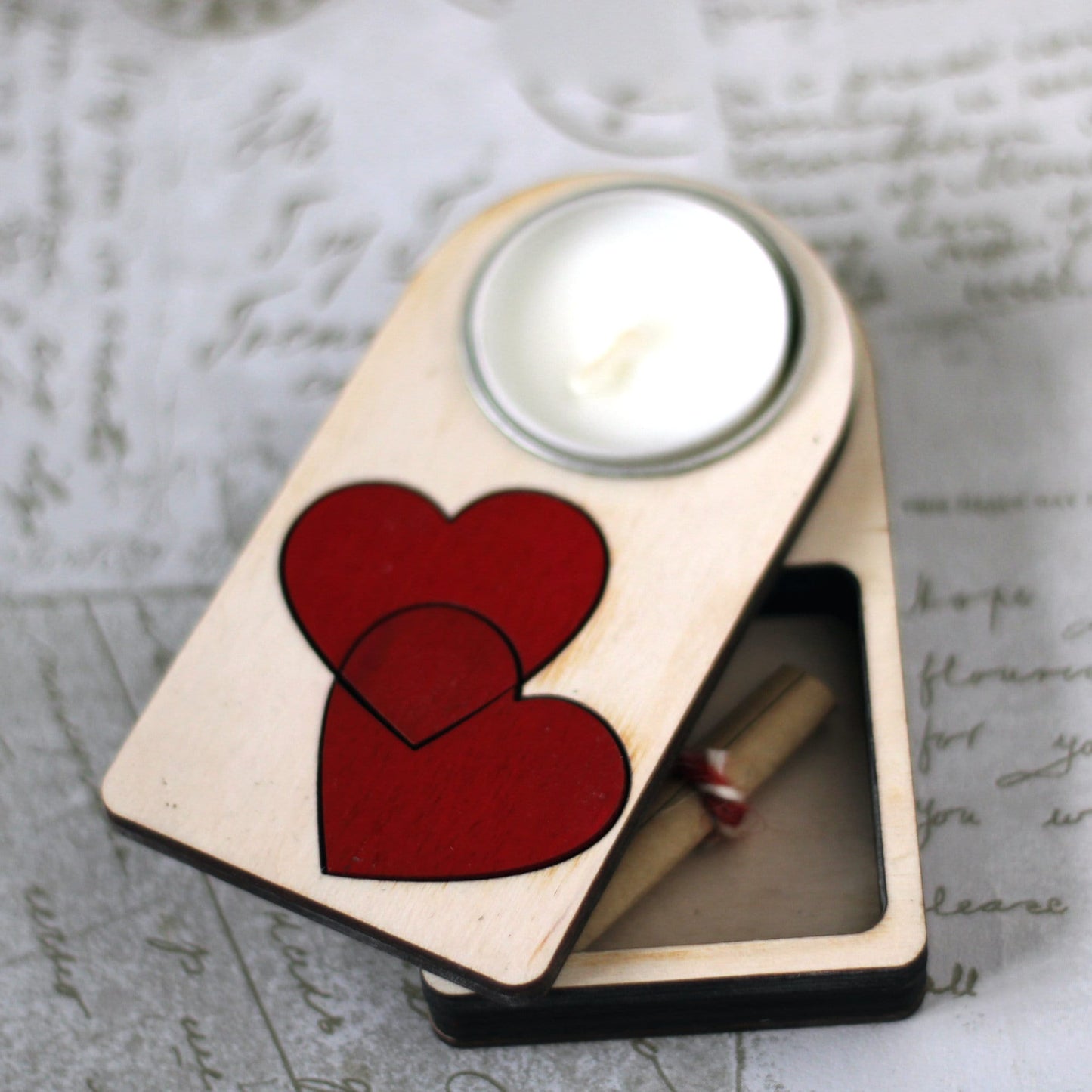 Engraved wooden candle holder with entwined hearts motif and secret compartment, it holds tea light candle or nightlight