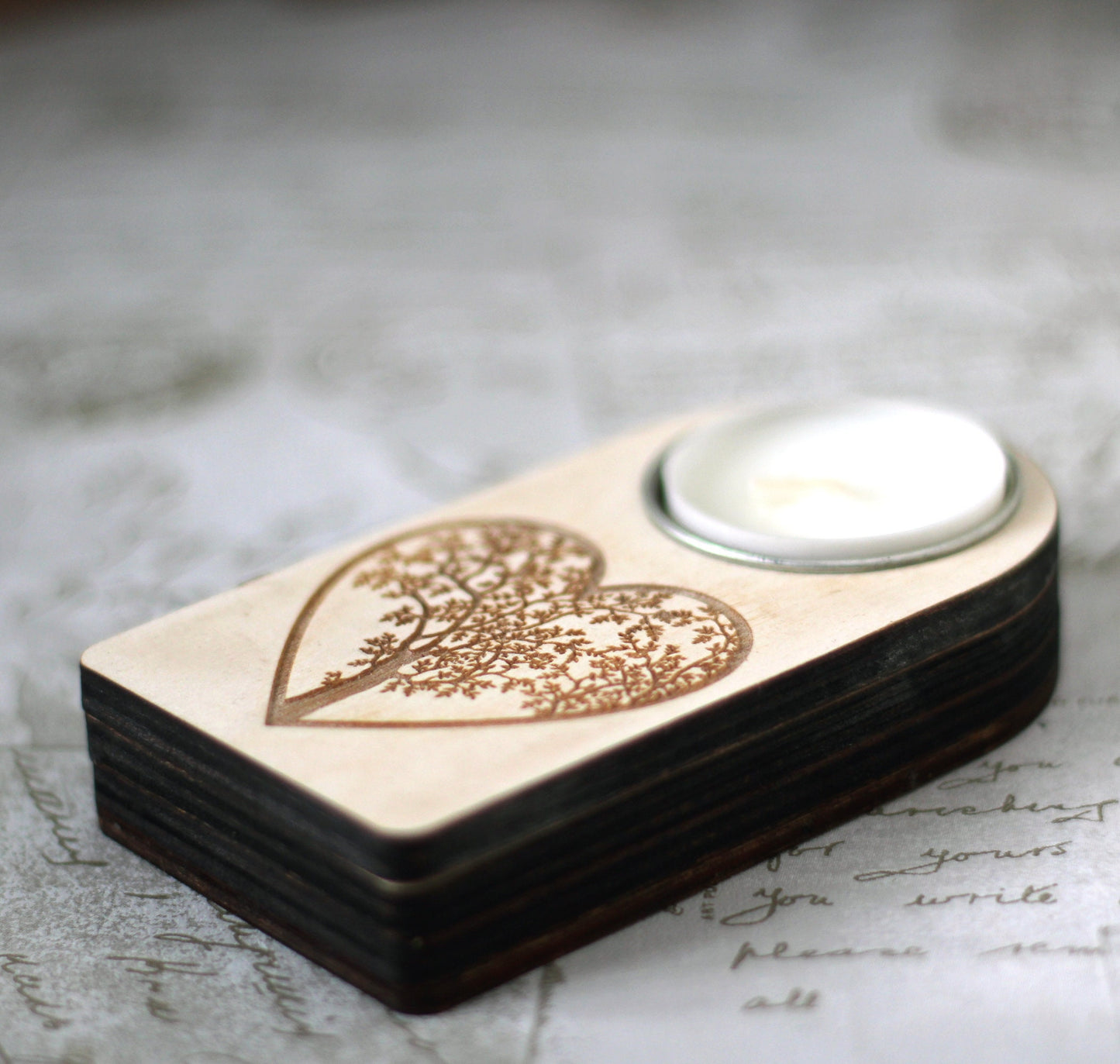 Engraved wooden candle holder with heart tree motif and secret compartment, it holds tea light candle or nightlight
