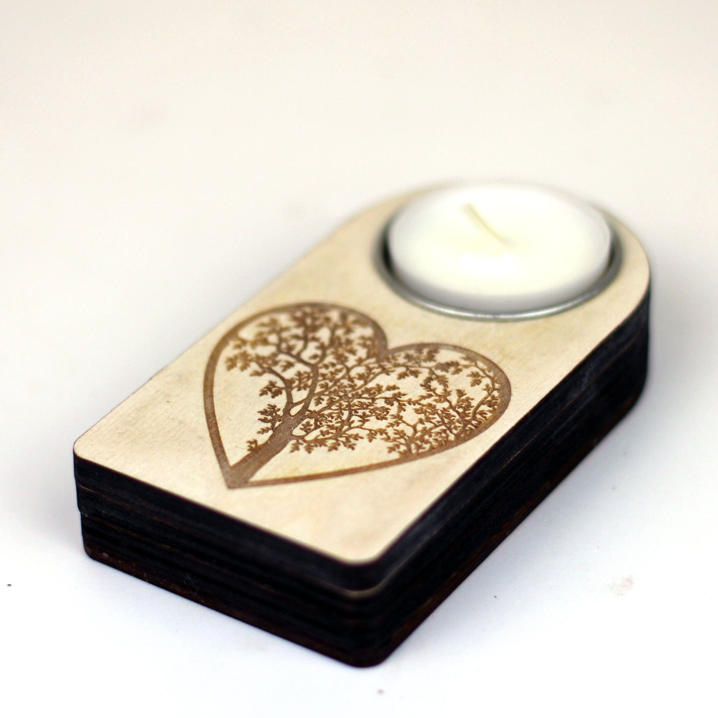 Engraved wooden candle holder with heart tree motif and secret compartment, it holds tea light candle or nightlight